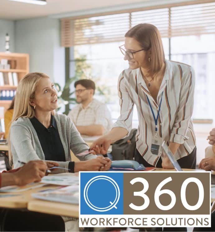 School staff members talking at a desk cluster