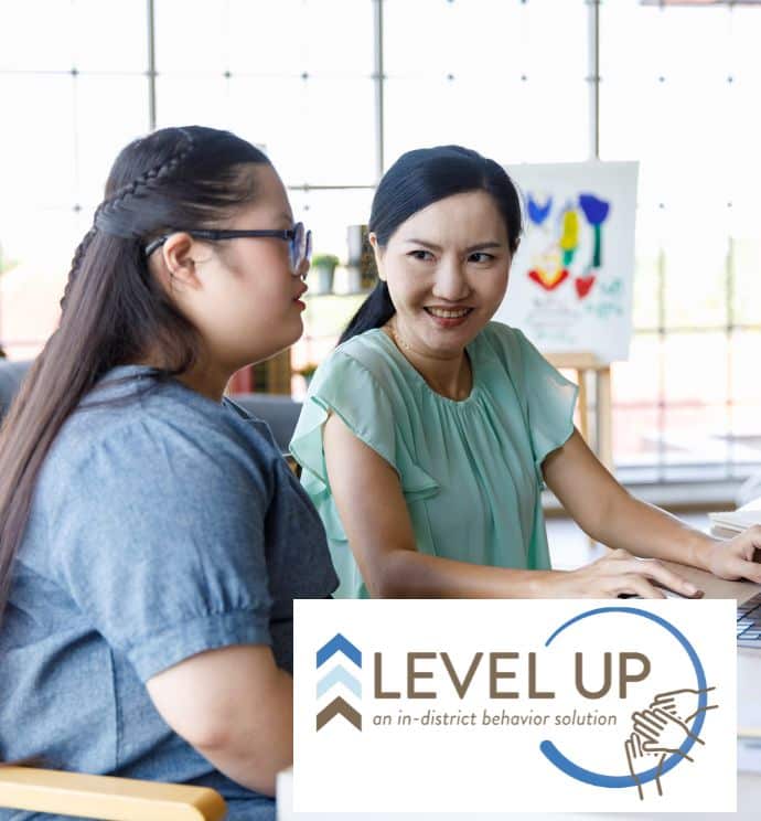 Teacher and student with a disability working together at a desk