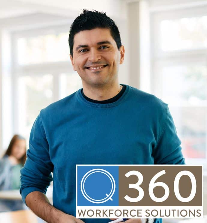 Male teacher in blue sweater smiling