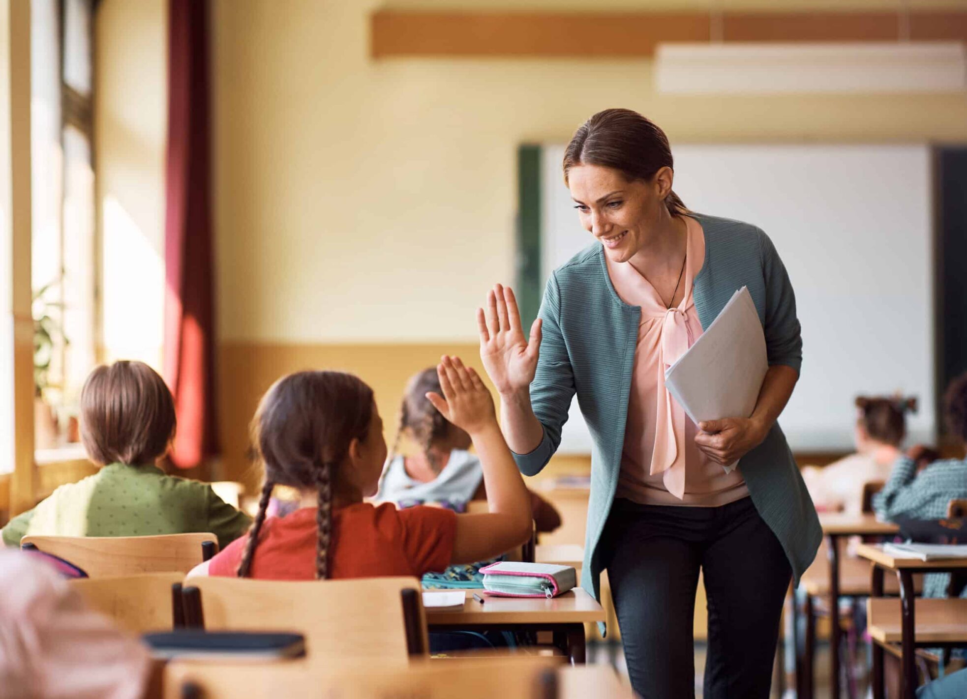 Teacher giving student high five