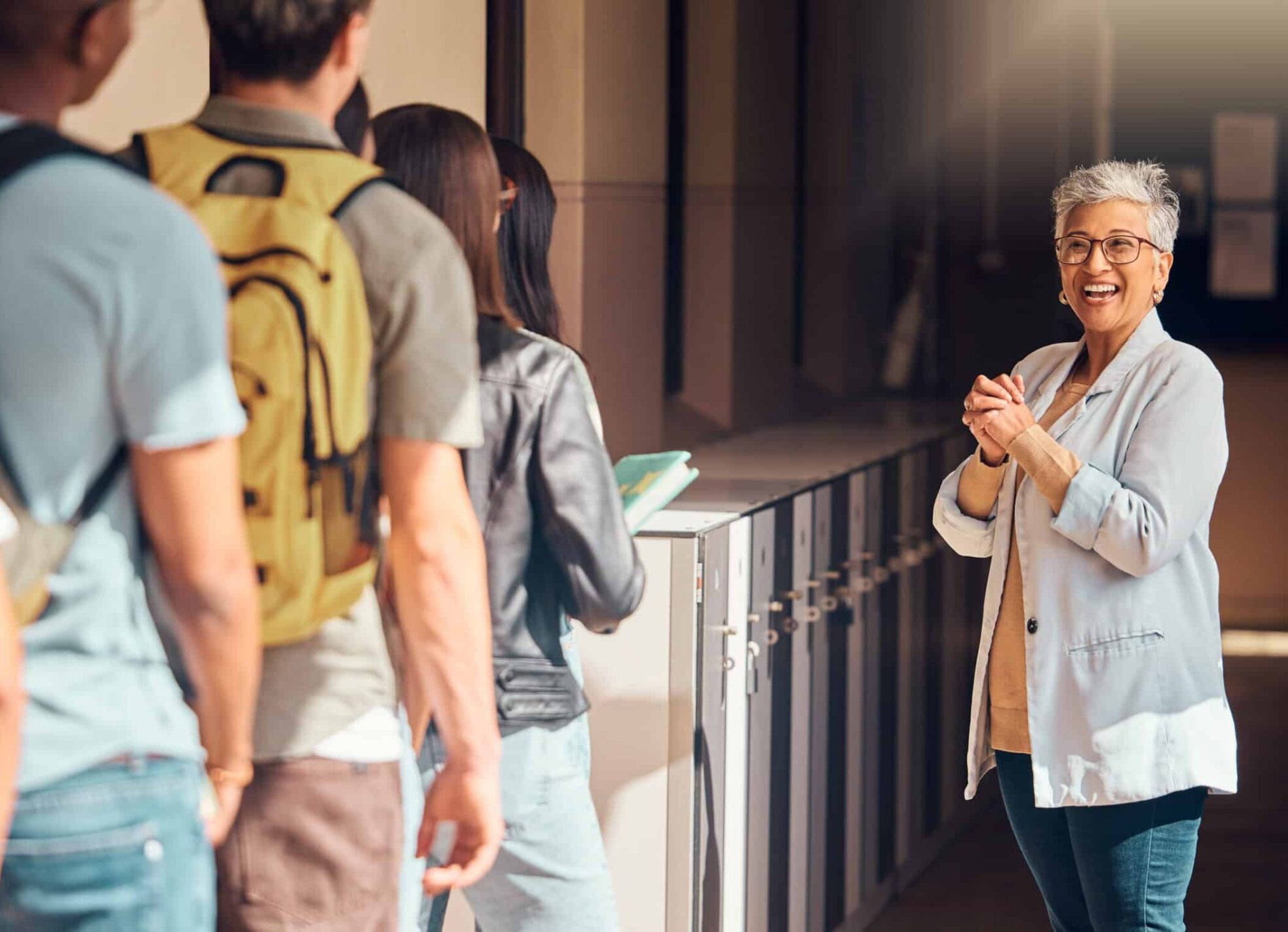 Teacher welcoming students before class