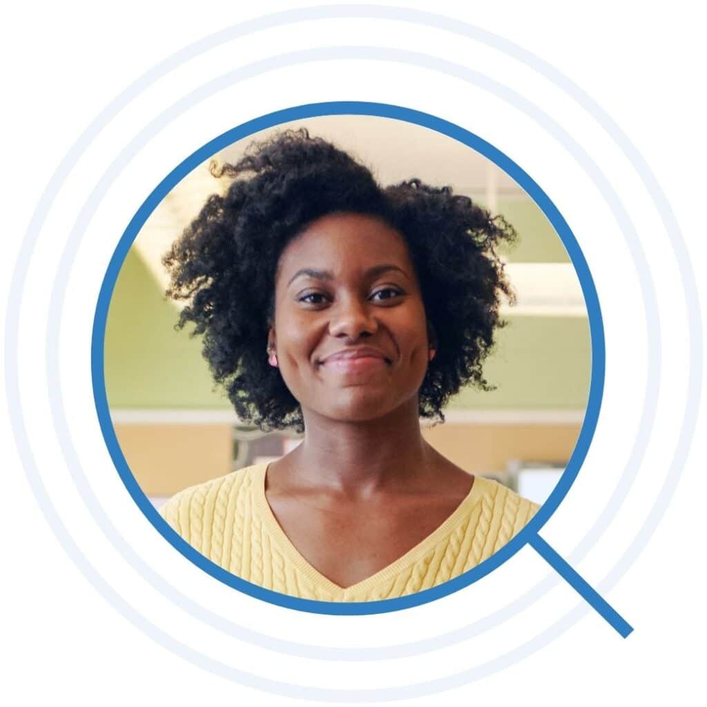 Teacher smiling proudly in her classroom