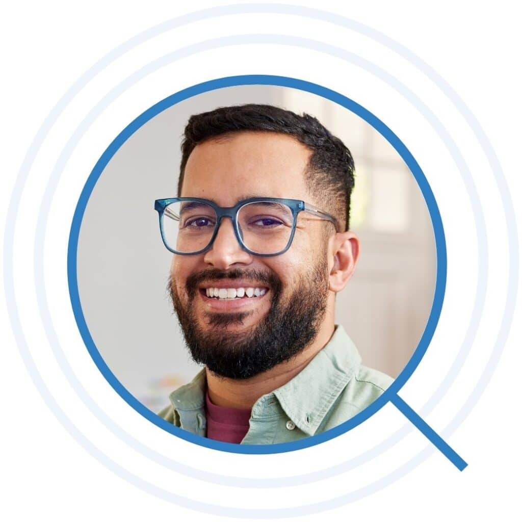 Happy male teacher smiling at primary school