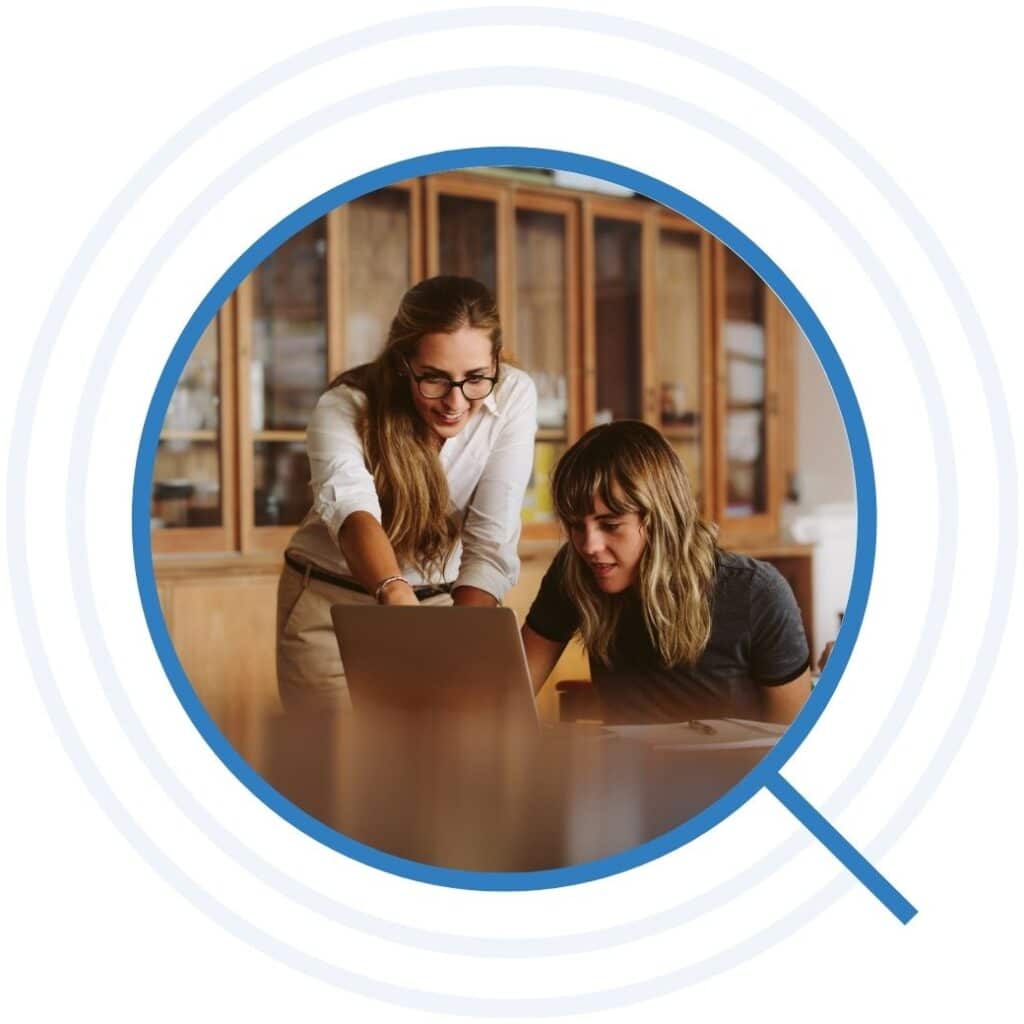 Two women looking at a laptop together