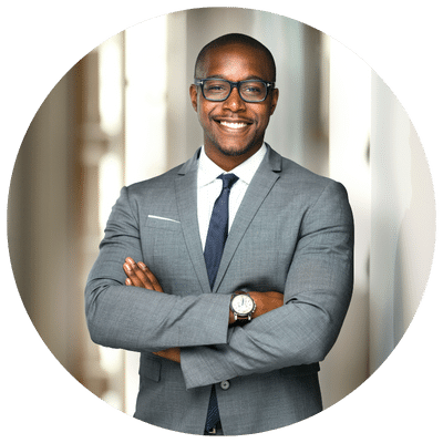 Man in suit smiling with arms crossed