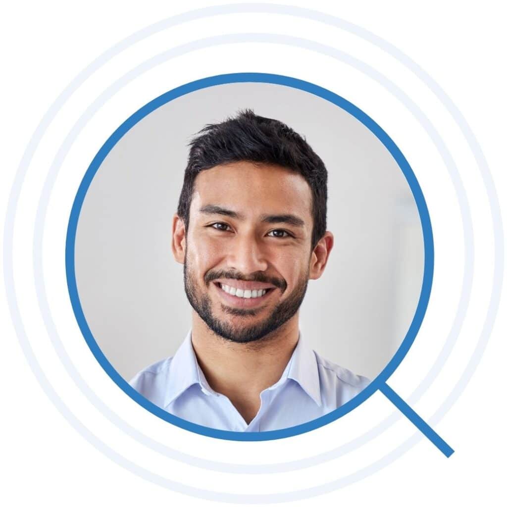 Man smiling in light blue button up