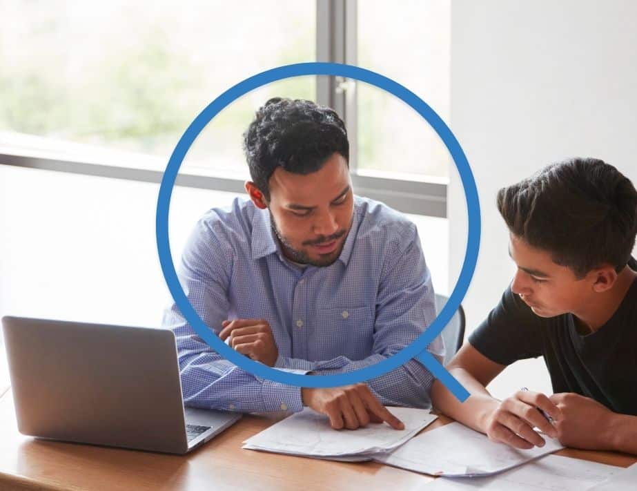 Staff member assisting student with classwork