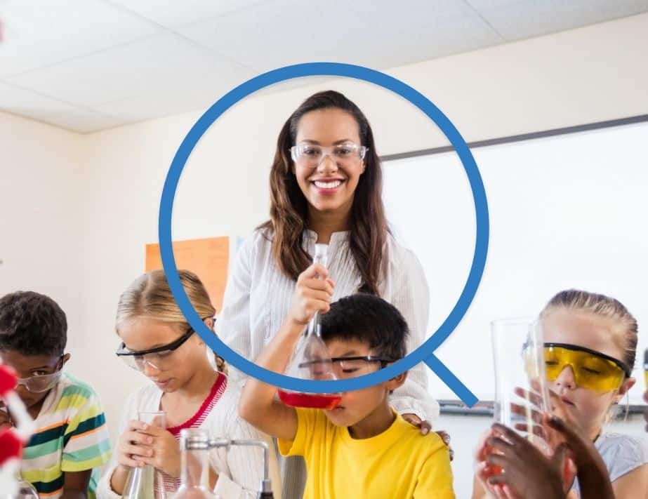 Science teacher performing experiments with the class