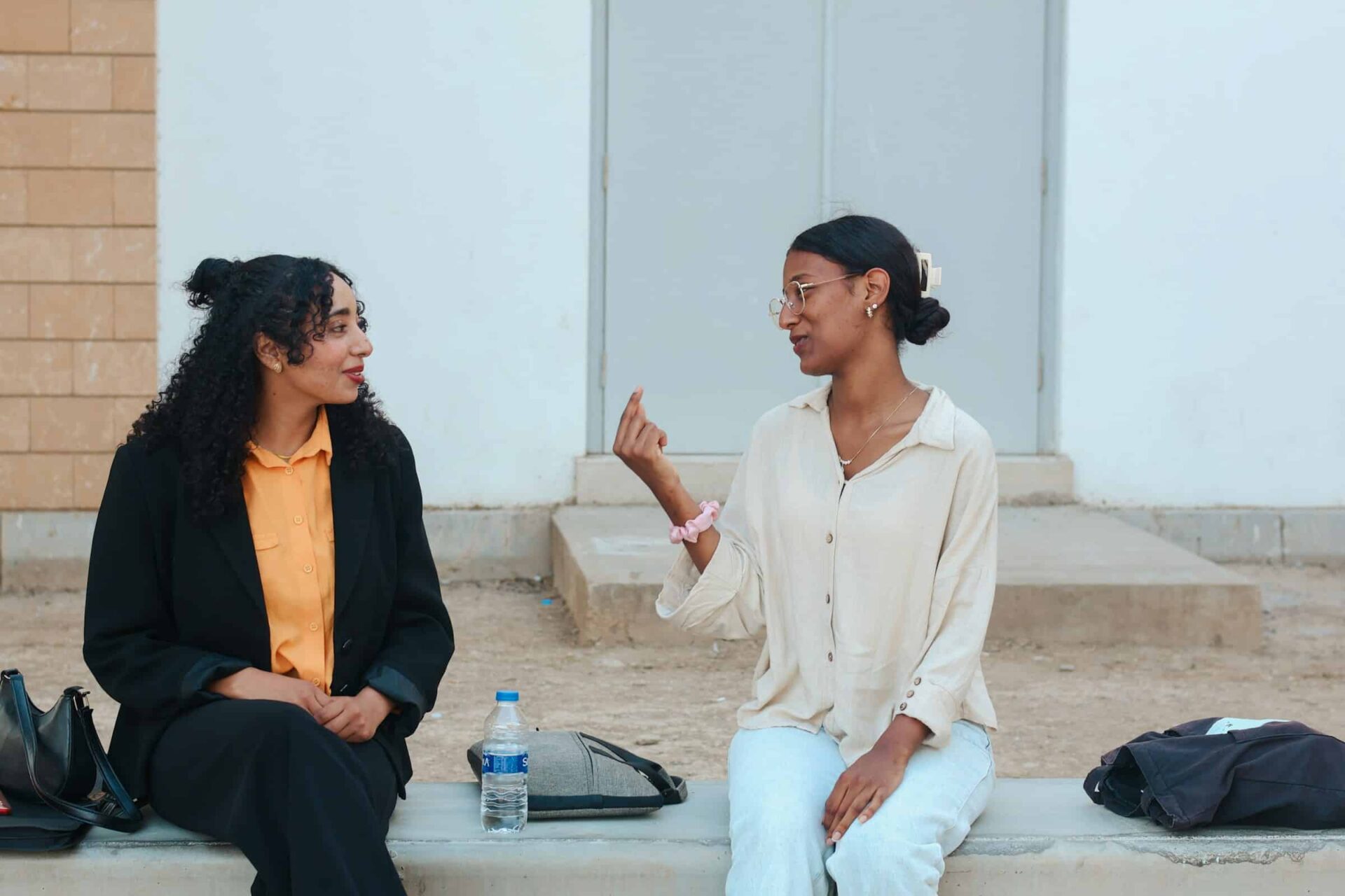 Two women sitting and talking on stairs