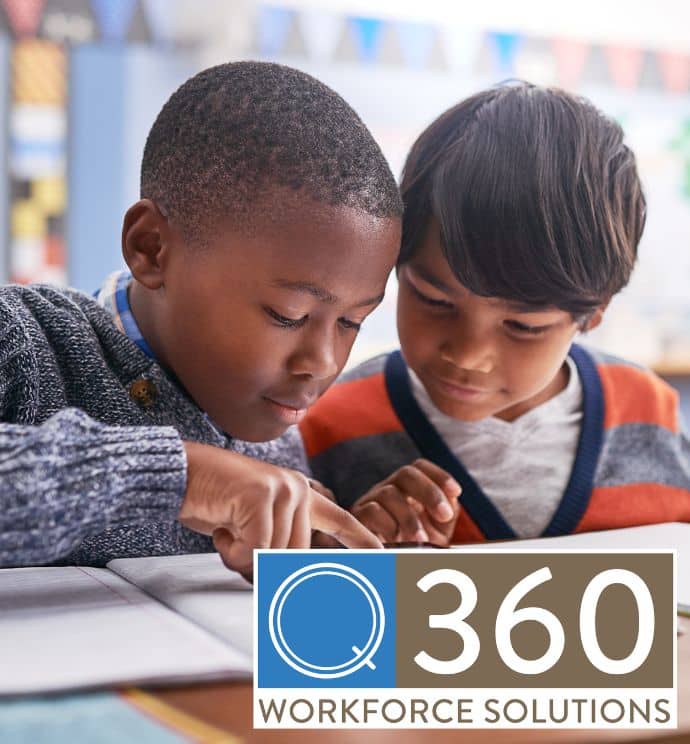 Two young boys reading together in class