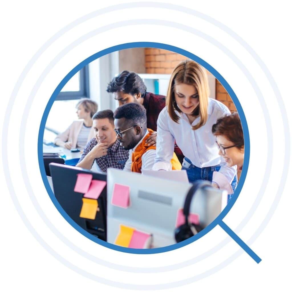 Staff busy at computers covered with sticky notes