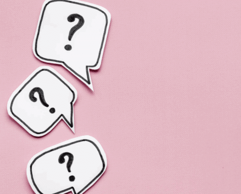 Three white speech bubbles with black question marks on a pink background, arranged diagonally from top left to bottom left.