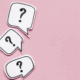 Three white speech bubbles with black question marks on a pink background, arranged diagonally from top left to bottom left.